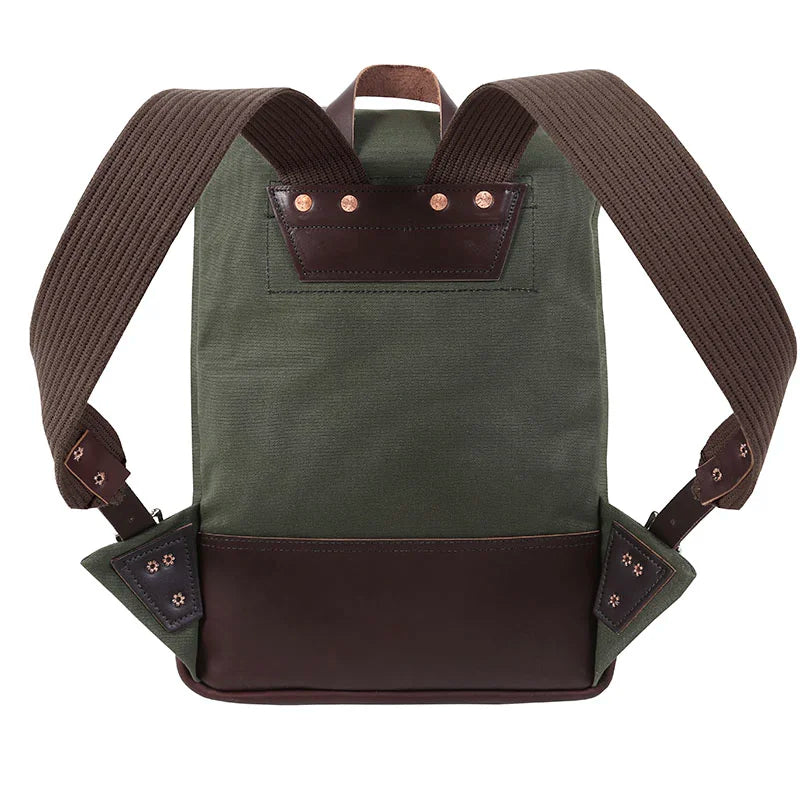 Deluxe Roll-Top Scout Pack in Olive Drab with leather accents, showcasing durable canvas and thick padded straps ideal for rugged outdoor use by Duluth Pack.