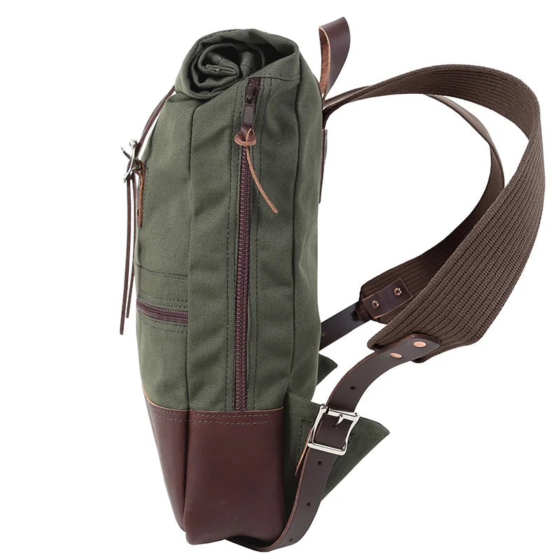 Deluxe Roll-Top Scout Pack in Olive Drab canvas and leather with adjustable strap, showcasing handcrafted durability by Duluth Pack for rugged outdoor use.