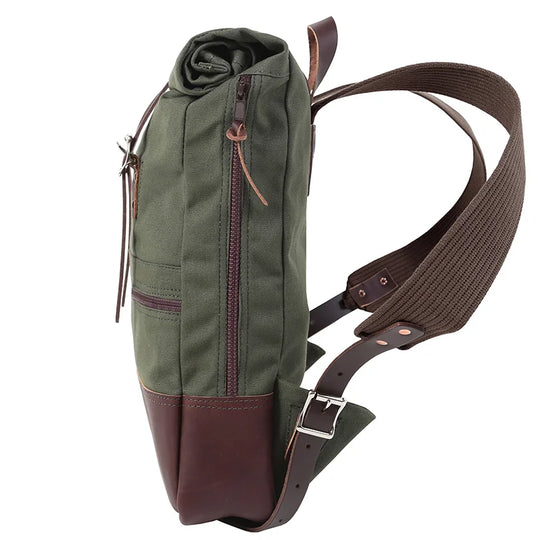 Deluxe Roll-Top Scout Pack in Olive Drab canvas and leather with adjustable strap, showcasing handcrafted durability by Duluth Pack for rugged outdoor use.