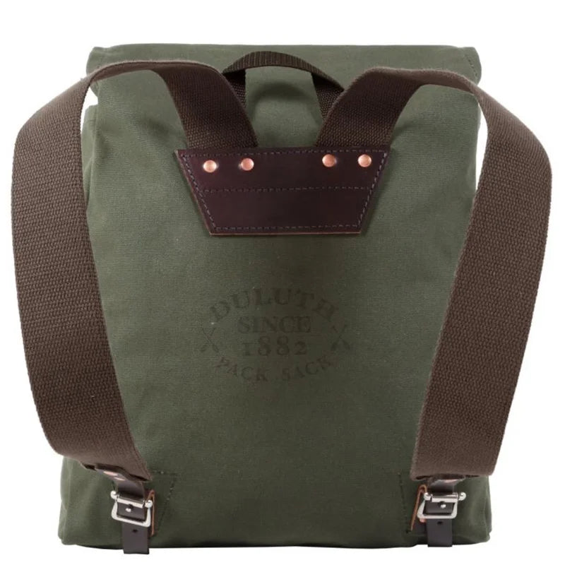 Ranger Pack in olive drab with rugged canvas and leather flap straps by Duluth Pack, designed for durable outdoor use and adventurous settings.