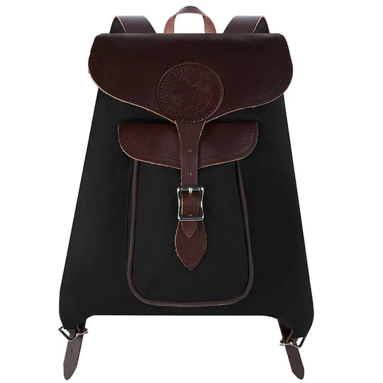 Rucksack Backpack in rugged black waxed canvas with brown leather straps, showcasing durable craftsmanship for outdoor and everyday use by Duluth Pack.