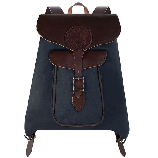 Rucksack Backpack in navy waxed canvas with leather straps by Duluth Pack, designed for rugged outdoor use and everyday reliability.