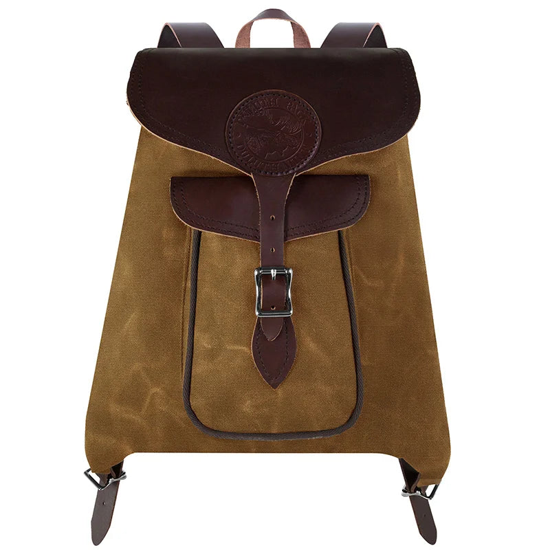Rucksack Backpack in rugged waxed canvas with reinforced leather straps by Duluth Pack, designed for durable outdoor and everyday use.