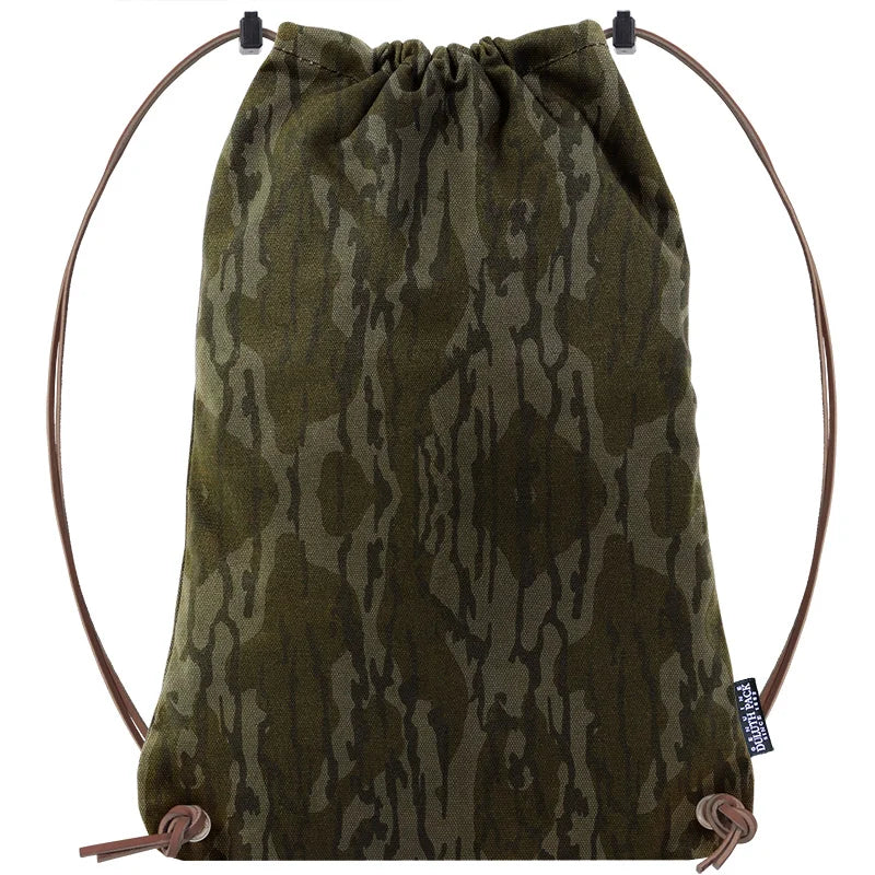 Drawstring Backpack in camo pattern with premium leather adjustable drawstrings, handmade by Duluth Pack for durable outdoor use and rugged adventures.