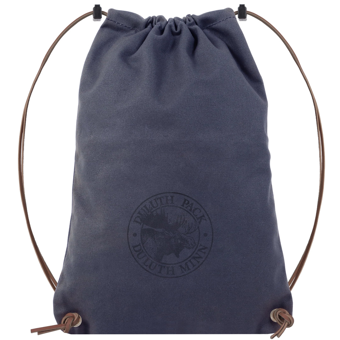 Drawstring Backpack in navy canvas with premium adjustable leather drawstrings, handcrafted by Duluth Pack for durable outdoor use and rugged everyday carry.