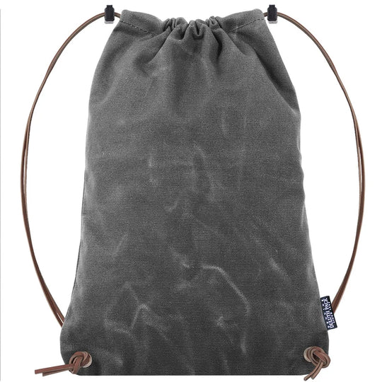 Drawstring Backpack in rugged grey waxed canvas with premium adjustable leather drawstrings, crafted by Duluth Pack for durable outdoor use.