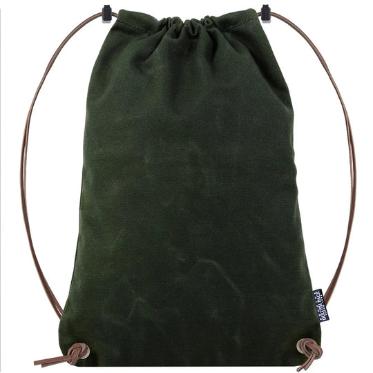 Drawstring Backpack in dark green canvas with premium leather adjustable straps by Duluth Pack, designed for rugged outdoor use and long-lasting durability.