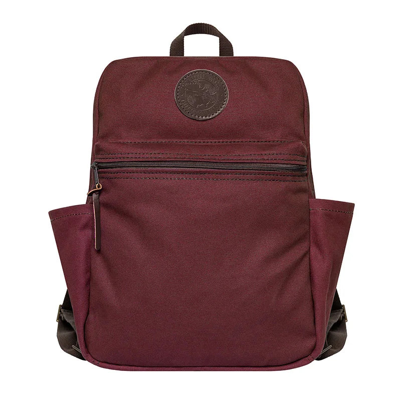 NEW Standard Backpack in burgundy with side pockets and front zip pocket, handmade canvas and leather by Duluth Pack for durable outdoor use.