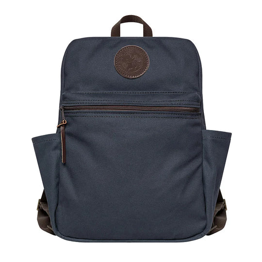 NEW Standard Backpack in navy with leather accents, featuring durable handmade canvas and side pockets, designed for rugged outdoor use and everyday durability.