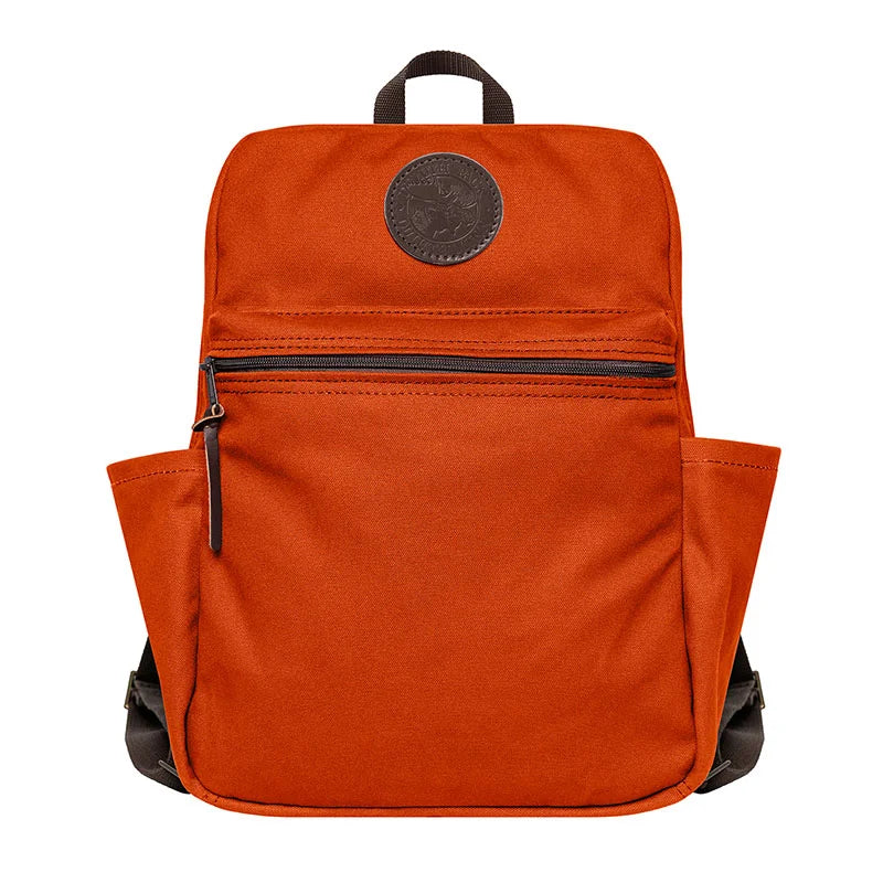 NEW Standard Backpack in orange with durable canvas and leather details, designed by Duluth Pack for rugged outdoor use and everyday school adventures.