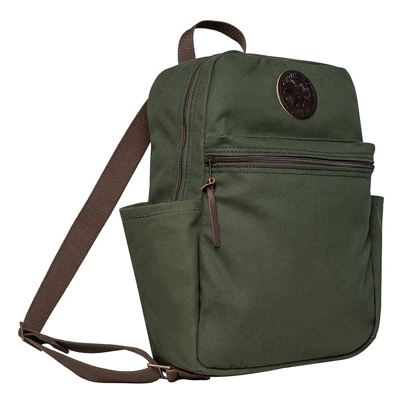 NEW Standard Backpack in Olive Drab color, featuring durable canvas material, side pockets for essentials, and a front zip compartment for everyday outdoor use.