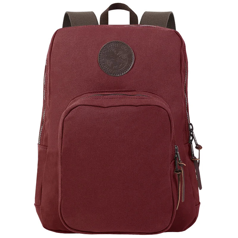 Large Standard Backpack in burgundy canvas with durable leather accents, designed by Duluth Pack for rugged outdoor use and lasting performance.