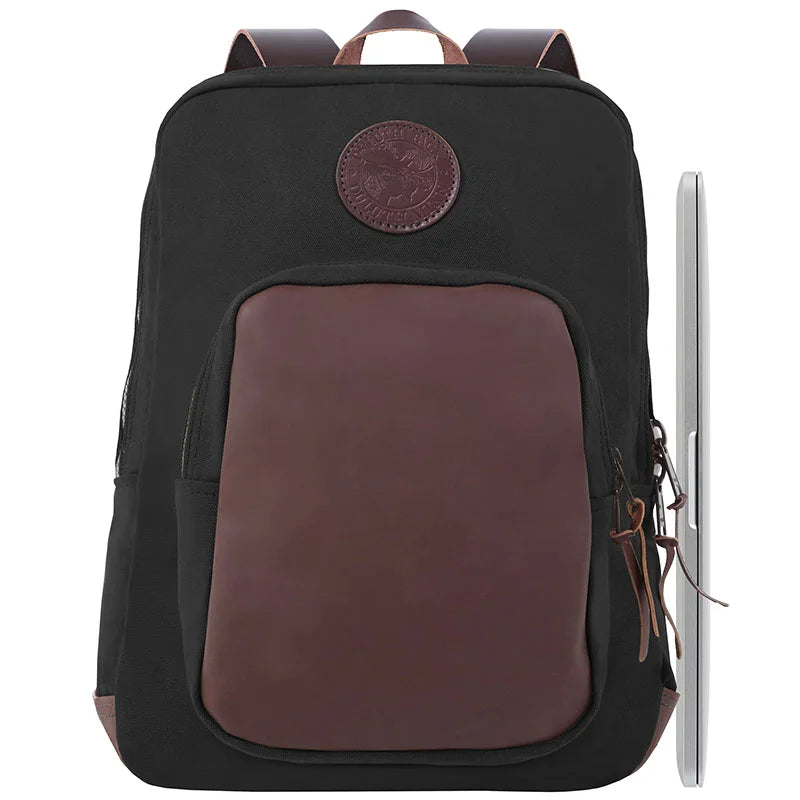 Deluxe Laptop Backpack in black with burgundy leather accents, featuring rugged canvas and durable brass hardware, designed for outdoor and travel use by Duluth Pack.