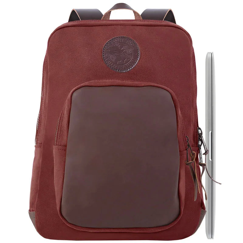 Deluxe Laptop Backpack in Burgundy featuring rugged canvas and leather accents, designed by Duluth Pack for durable outdoor use and reliable laptop protection.