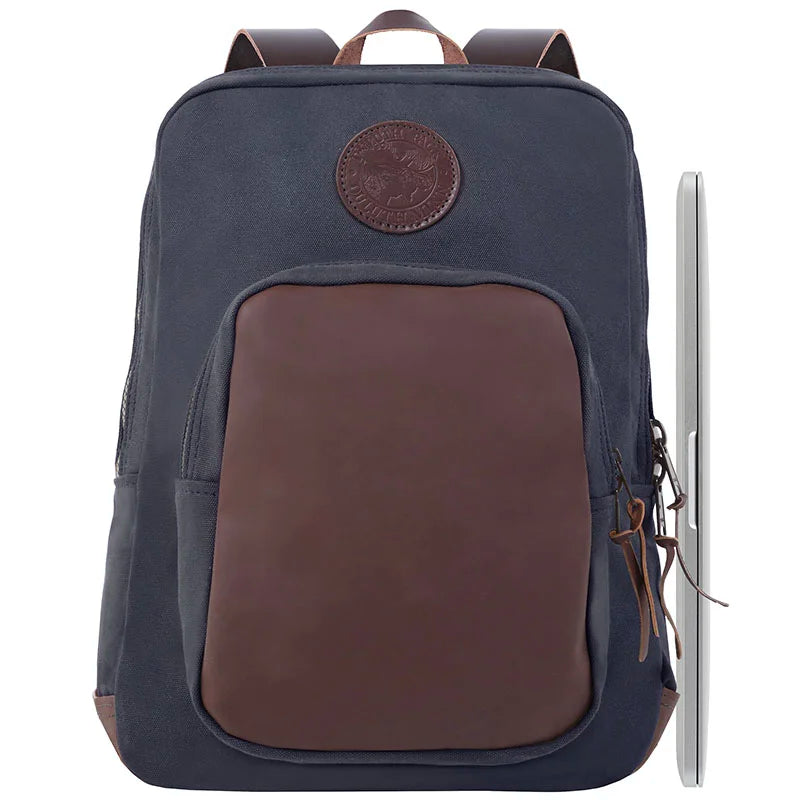 Deluxe Laptop Backpack in navy with brown leather accents, featuring rugged canvas material and durable YKK zippers, styled for outdoor and everyday use.
