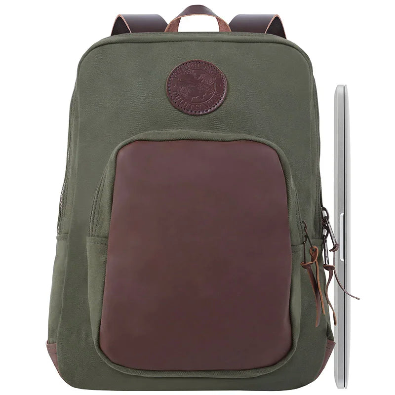 Deluxe Laptop Backpack in olive drab with leather accents, handmade from rugged canvas, featuring durable YKK zippers, shown with a laptop for scale and outdoor use.