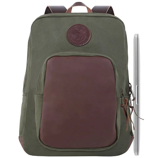 Deluxe Laptop Backpack in olive drab with leather accents, handmade from rugged canvas, featuring durable YKK zippers, shown with a laptop for scale and outdoor use.