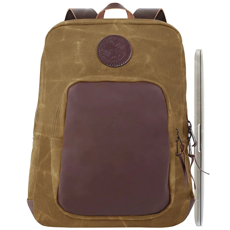 Deluxe Laptop Backpack in waxed khaki canvas with rich leather accents, featuring durable construction and practical design for rugged outdoor use by Duluth Pack.