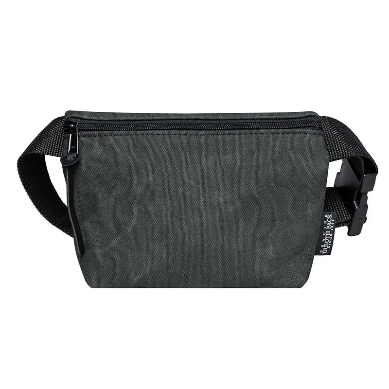 Mini Belt Bag in waxed grey canvas with black adjustable strap, designed by Duluth Pack for durable, hands-free carrying of essentials outdoors.