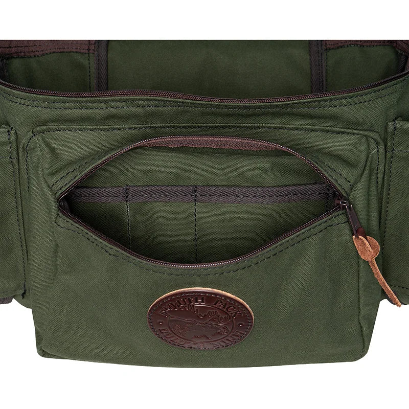 All Day Lumbar Pack in Olive Drab with a front zippered pocket and leather logo patch, showcasing durable canvas and rugged outdoor design by Duluth Pack.