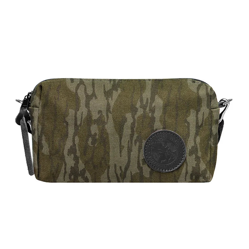 Riverwalk Purse in Mossy Oak Bottomland Camo canvas with leather patch and adjustable cotton web shoulder strap, perfect for rugged outdoor use.