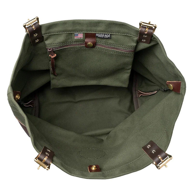Deluxe Market Tote in Olive Drab featuring handmade canvas and leather interior with brass roller buckles, showcasing durable craftsmanship by Duluth Pack.