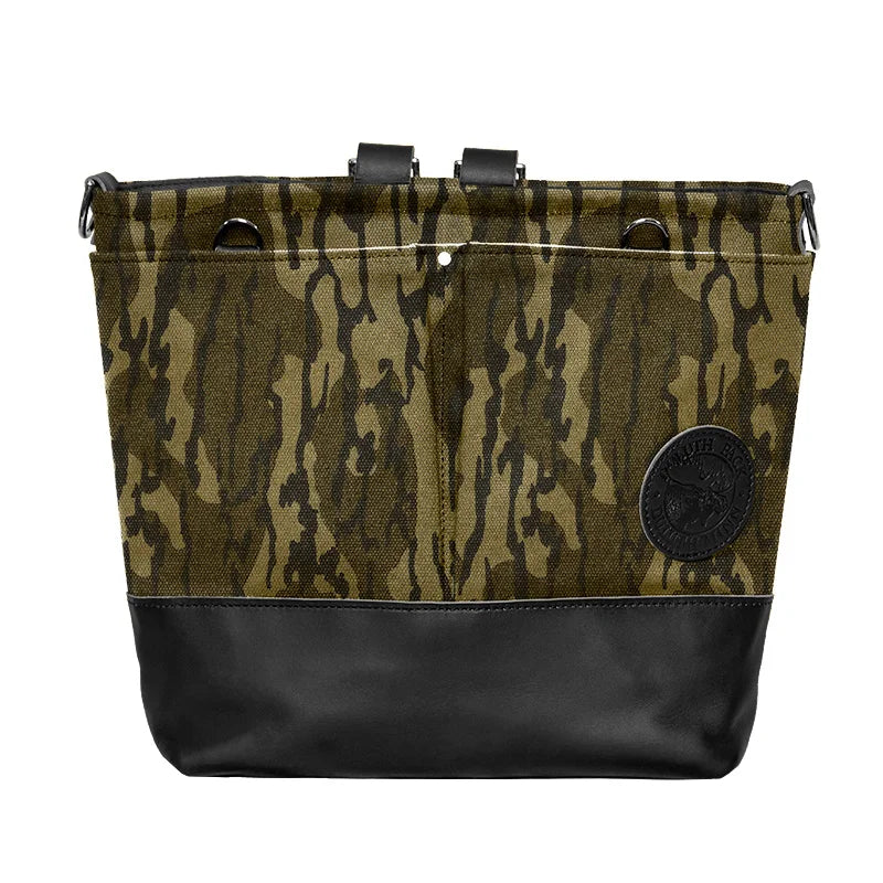 Convertible Jet-Setter Tote in Mossy Oak Bottomland Camo with black leather base, featuring durable canvas and leather craftsmanship for rugged outdoor use.