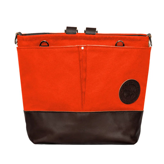 Convertible Jet-Setter Tote in orange canvas with dark leather bottom, featuring multiple attachment points and front pockets, crafted by Duluth Pack for rugged outdoor use.