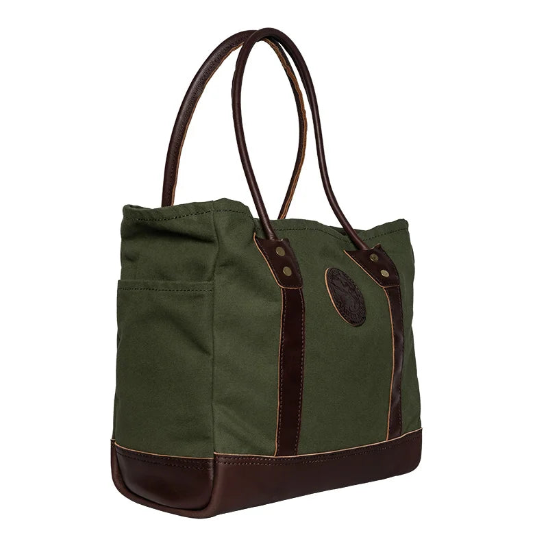 Highlander Tote in Olive Drab with leather trim, featuring durable canvas construction and designed for outdoor use by Duluth Pack.