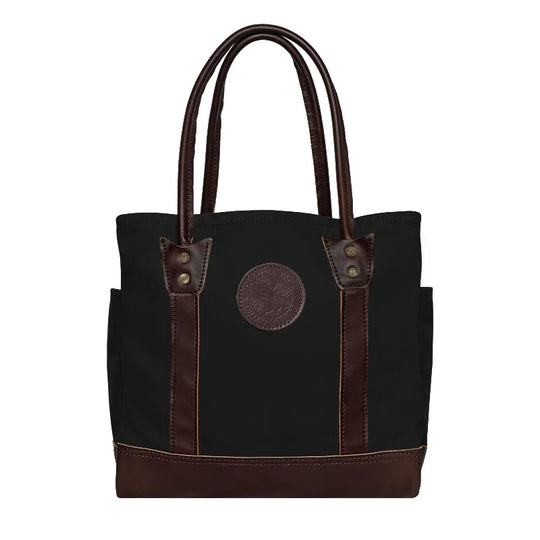 Highlander Tote in black with brown leather accents, handmade by Duluth Pack, designed for durable outdoor use and versatile everyday carrying.