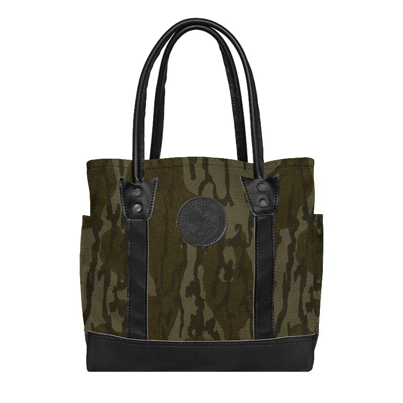 Highlander Tote in Mossy Oak Bottomland Camo with black leather accents, a durable handmade canvas tote perfect for rugged outdoor use and everyday carry by Duluth Pack.