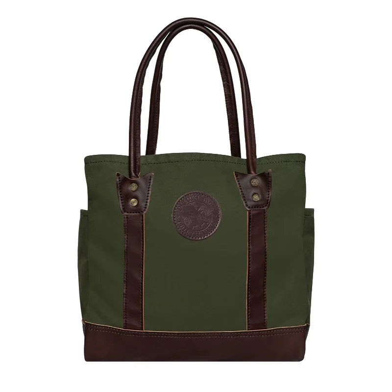 Highlander Tote in Olive Drab with leather accents, featuring durable canvas construction and sturdy handles, perfect for rugged outdoor use by Duluth Pack.