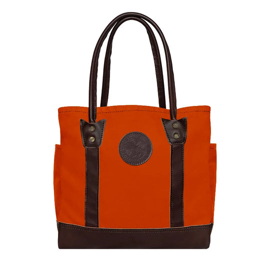 Highlander Tote in bright orange with dark leather handles and accents by Duluth Pack, crafted for durable everyday use and rugged outdoor settings.
