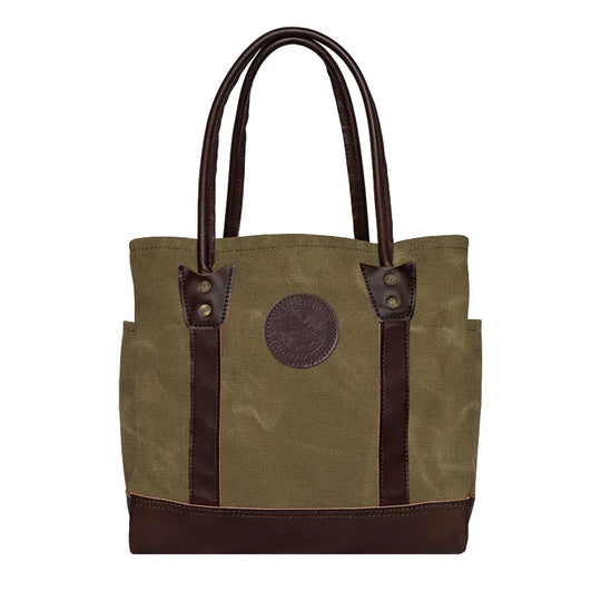Highlander Tote in waxed khaki with dark leather accents, featuring durable canvas and leather construction, ideal for rugged outdoor use by Duluth Pack.