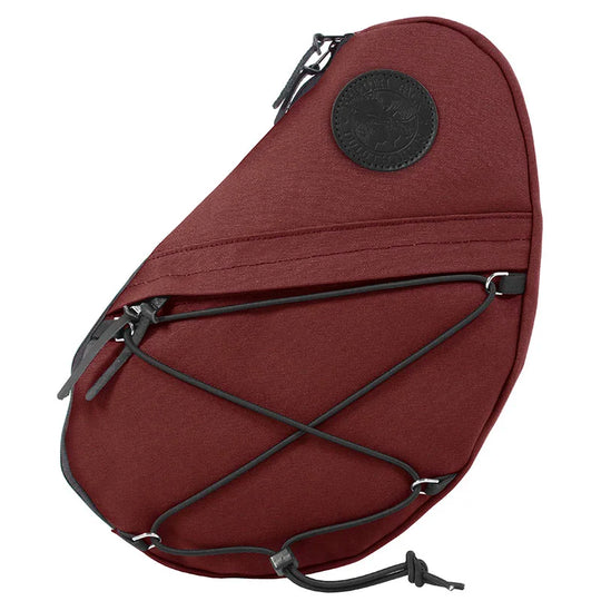 Sling Pack in burgundy featuring durable handmade 15 oz. canvas with adjustable bungee cords, designed for rugged outdoor use and versatile everyday carry.