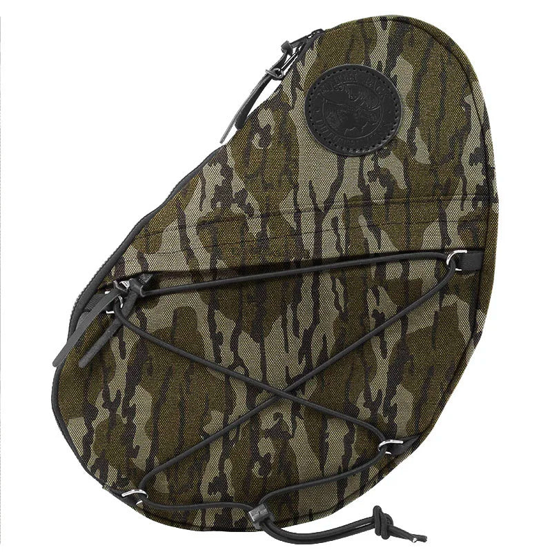 Sling Pack in Mossy Oak Bottomland Camo crafted from durable canvas, featuring external bungee cords for versatile outdoor use by Duluth Pack.