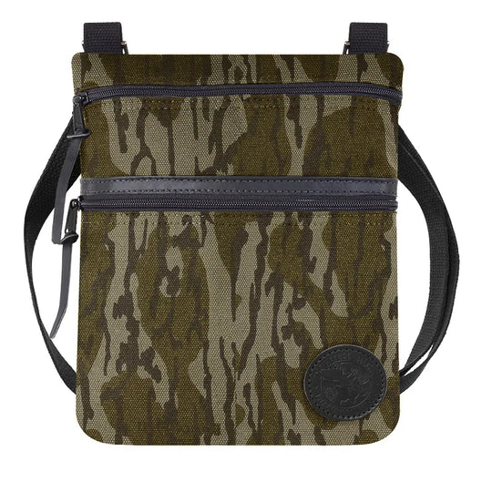 Traverse Crossbody Bag in Mossy Oak Bottomland Camo featuring durable canvas construction and dual zippered compartments, ideal for rugged outdoor use.