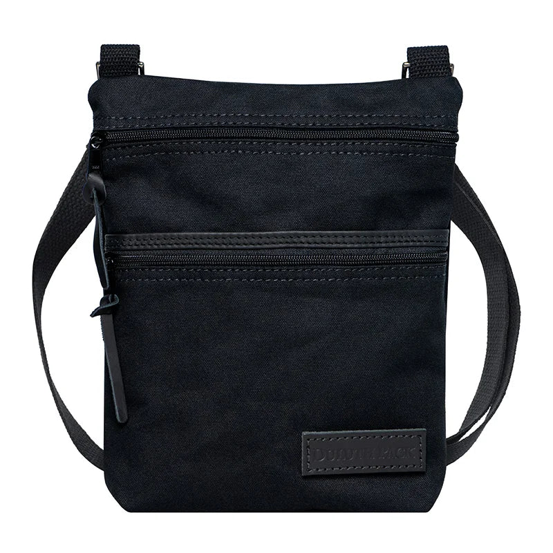 Superior Series Canvas Traverse Crossbody in black canvas with dual zippered compartments and adjustable cotton web shoulder strap, designed for everyday use and travel.