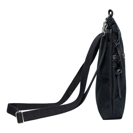 Superior Series Canvas Traverse Crossbody in black canvas with durable cotton web shoulder strap, shown from side for everyday and travel use by Duluth Pack.