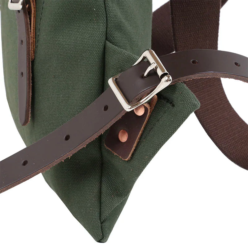 Scout Pack in Olive Drab with dark brown leather strap and silver buckle, showcasing durable canvas and traditional handmade construction for outdoor use.