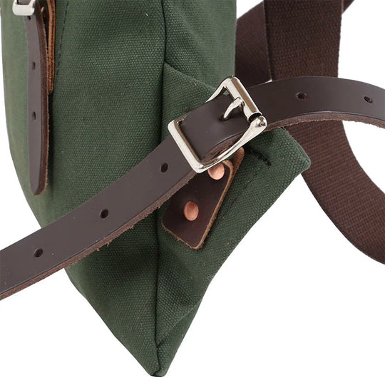 Scout Pack in Olive Drab with dark brown leather strap and silver buckle, showcasing durable canvas and traditional handmade construction for outdoor use.
