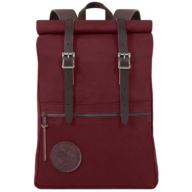 Roll-Top Scout Pack in deep brown canvas with leather straps, designed for rugged outdoor use and versatile packing by Duluth Pack.