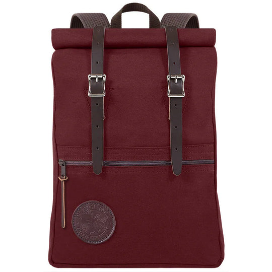Roll-Top Scout Pack in deep brown canvas with leather straps, designed for rugged outdoor use and versatile packing by Duluth Pack.