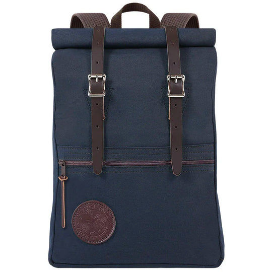 Roll-Top Scout Pack in navy canvas with brown leather straps, showcasing durable handmade craftsmanship ideal for outdoor adventures and rugged use.