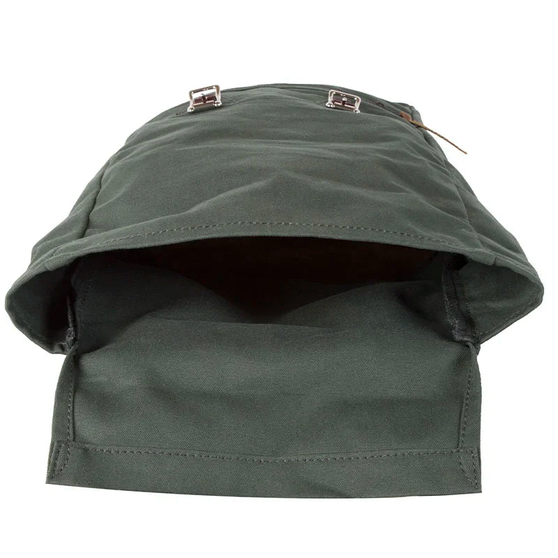 Roll-Top Scout Pack in dark green canvas with leather accents, open to show spacious interior, designed for durable outdoor use by Duluth Pack.