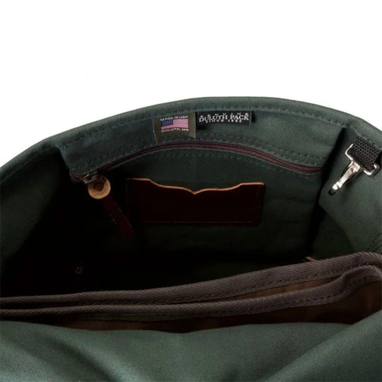 Laptop Scoutmaster in Waxed Olive Drab showing interior craftsmanship with leather trim and durable green canvas, designed for rugged outdoor and everyday use by Duluth Pack.