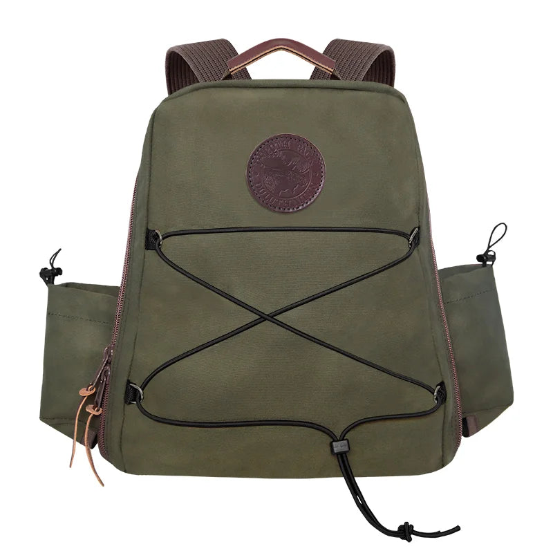 Woodsman's Pack in Olive Drab featuring rugged canvas construction and leather accents, designed for durable outdoor use by Duluth Pack.