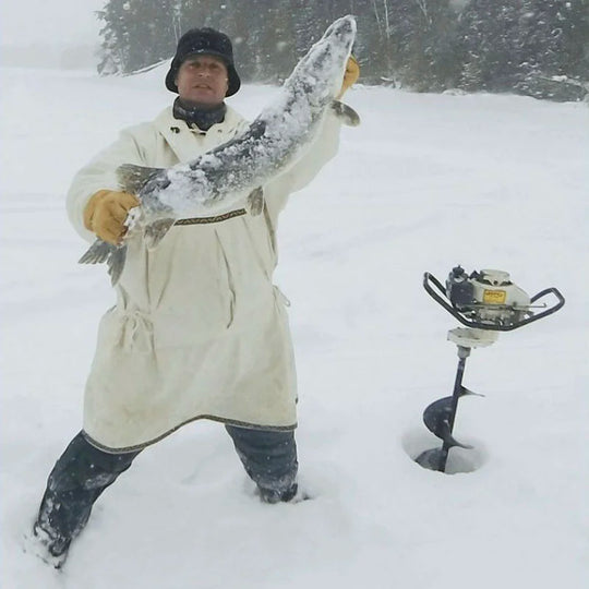Man in Anorak Ice Fishing with Muskie