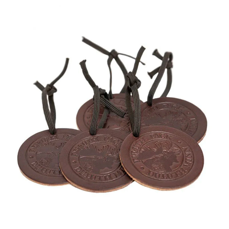 Pile of Round Leather Duluth Pack Logo Ornaments