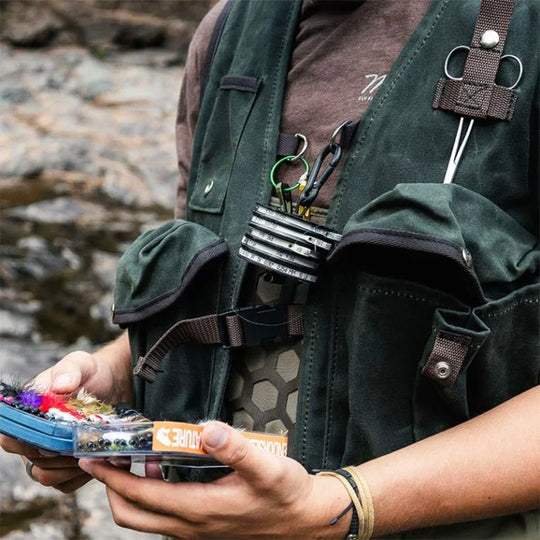 Fly Vest on a model holding box of tackle